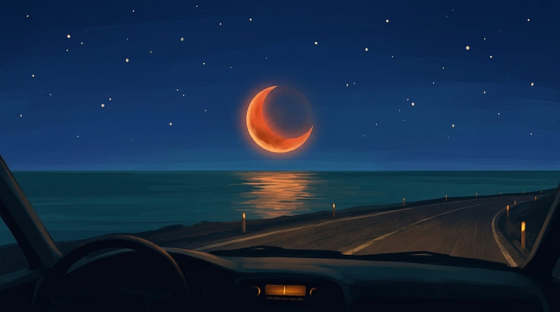 The view from the driver's seat at night: a dark dashboard with a small glowing radio dial, a black coastal road under a midnight sky, and a blood-orange eclipse moon low over the ocean